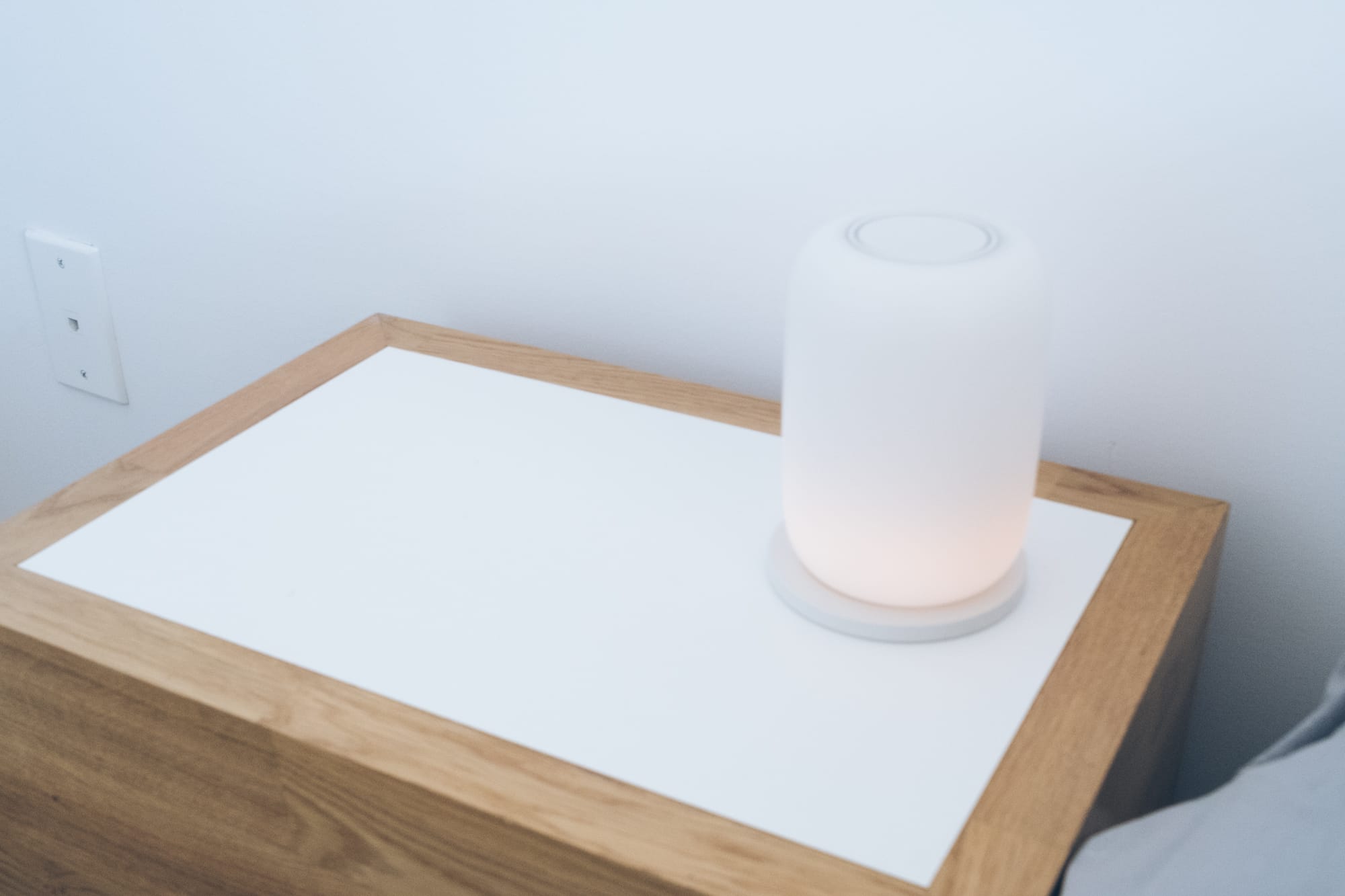 Casper glow lamp sitting on bedside table