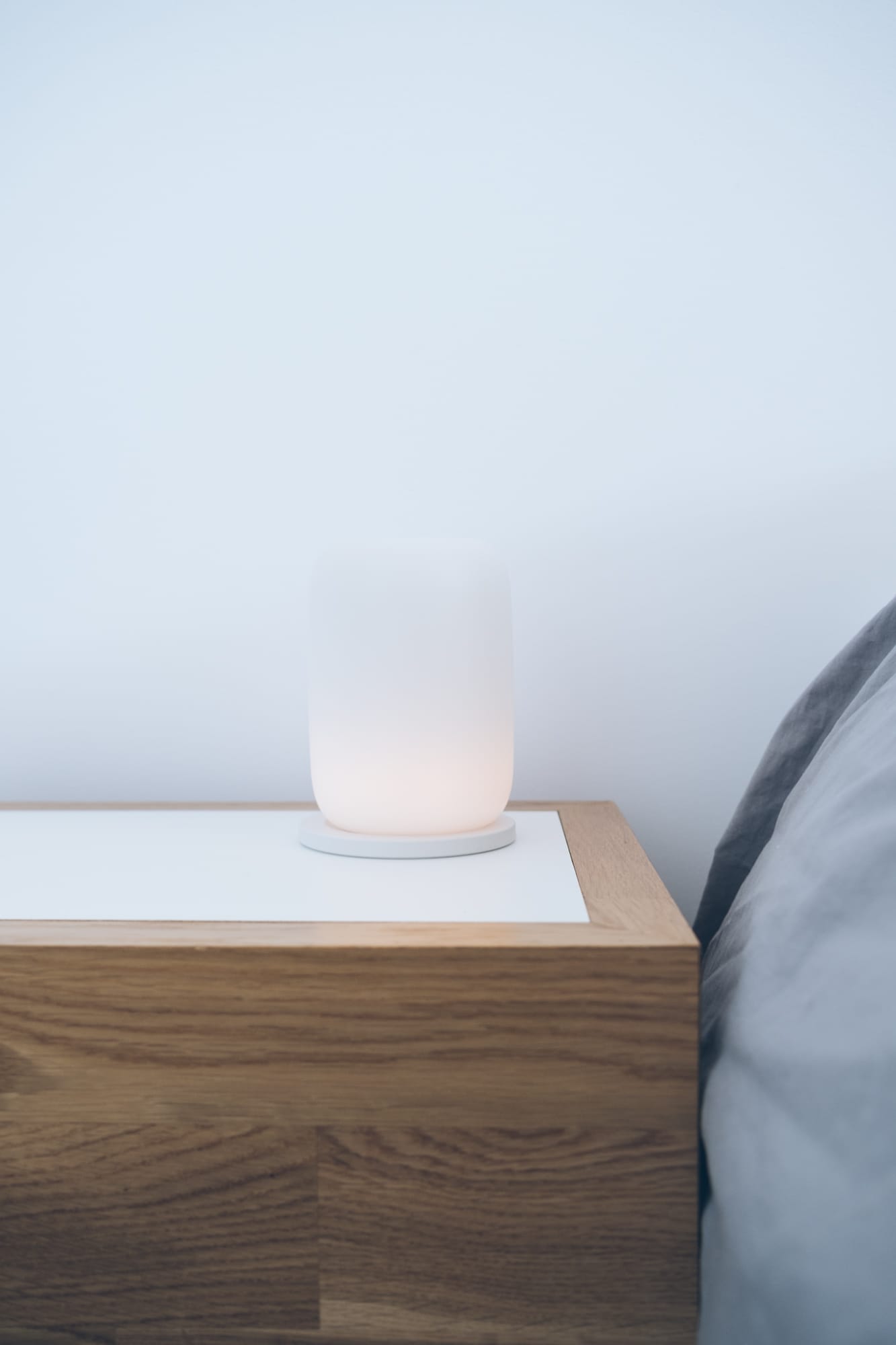 gasper glow lamp sitting on nightstand.