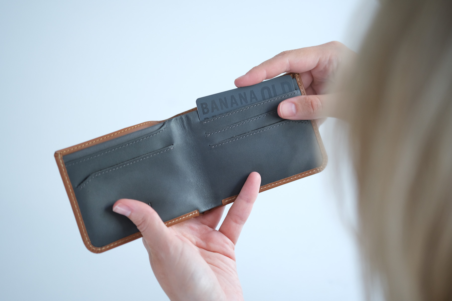 Bellroy wallet open with card being inserted
