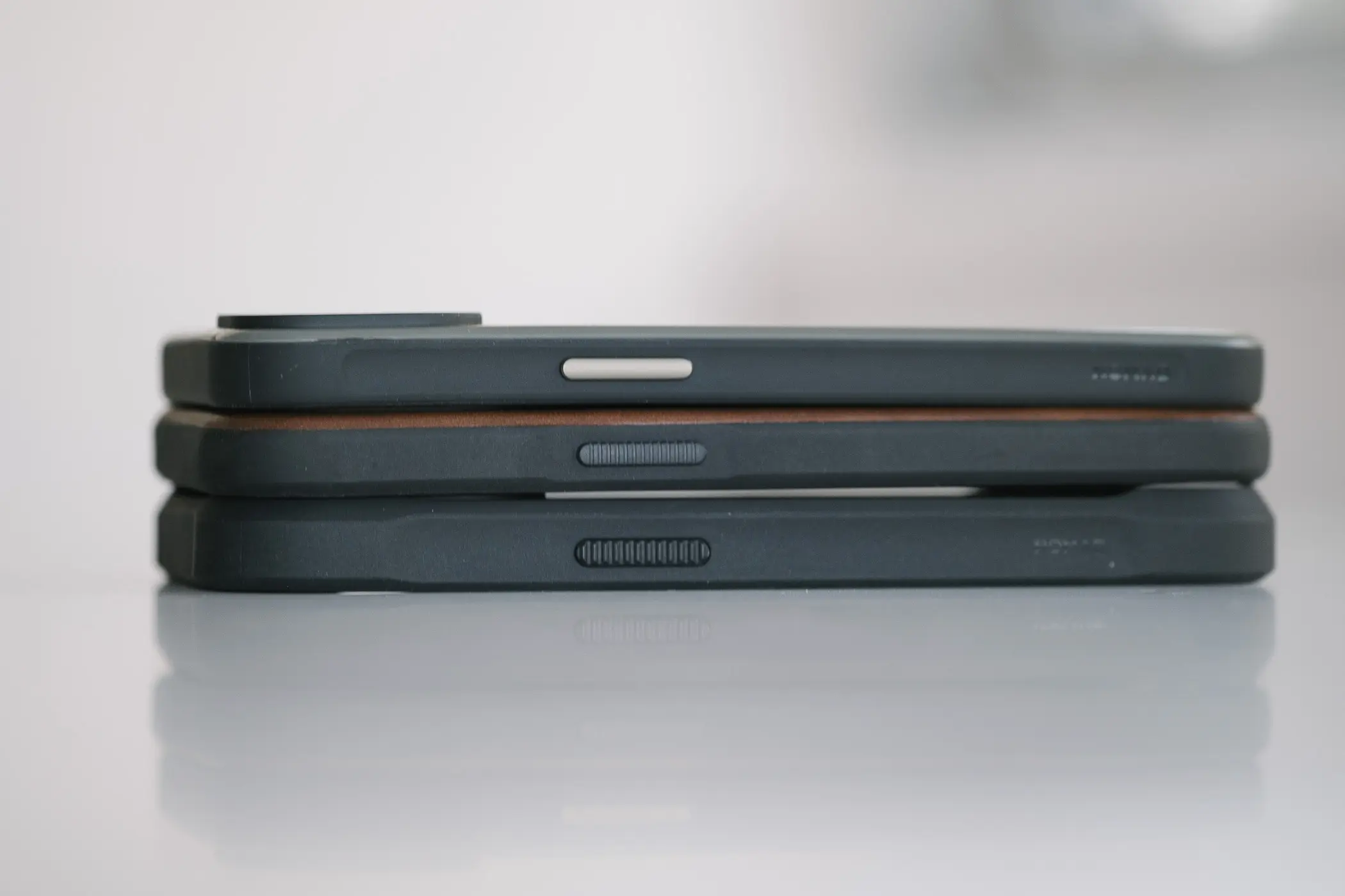 3 cases laying on top of each other showing thickness