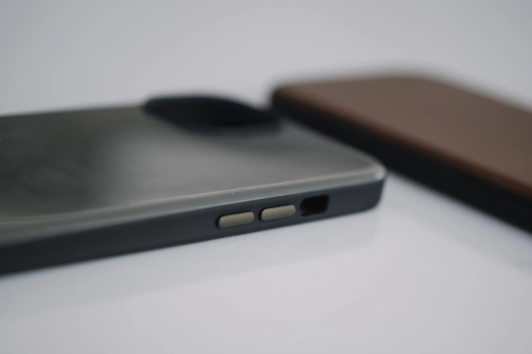 side of green phone case showing metal buttons