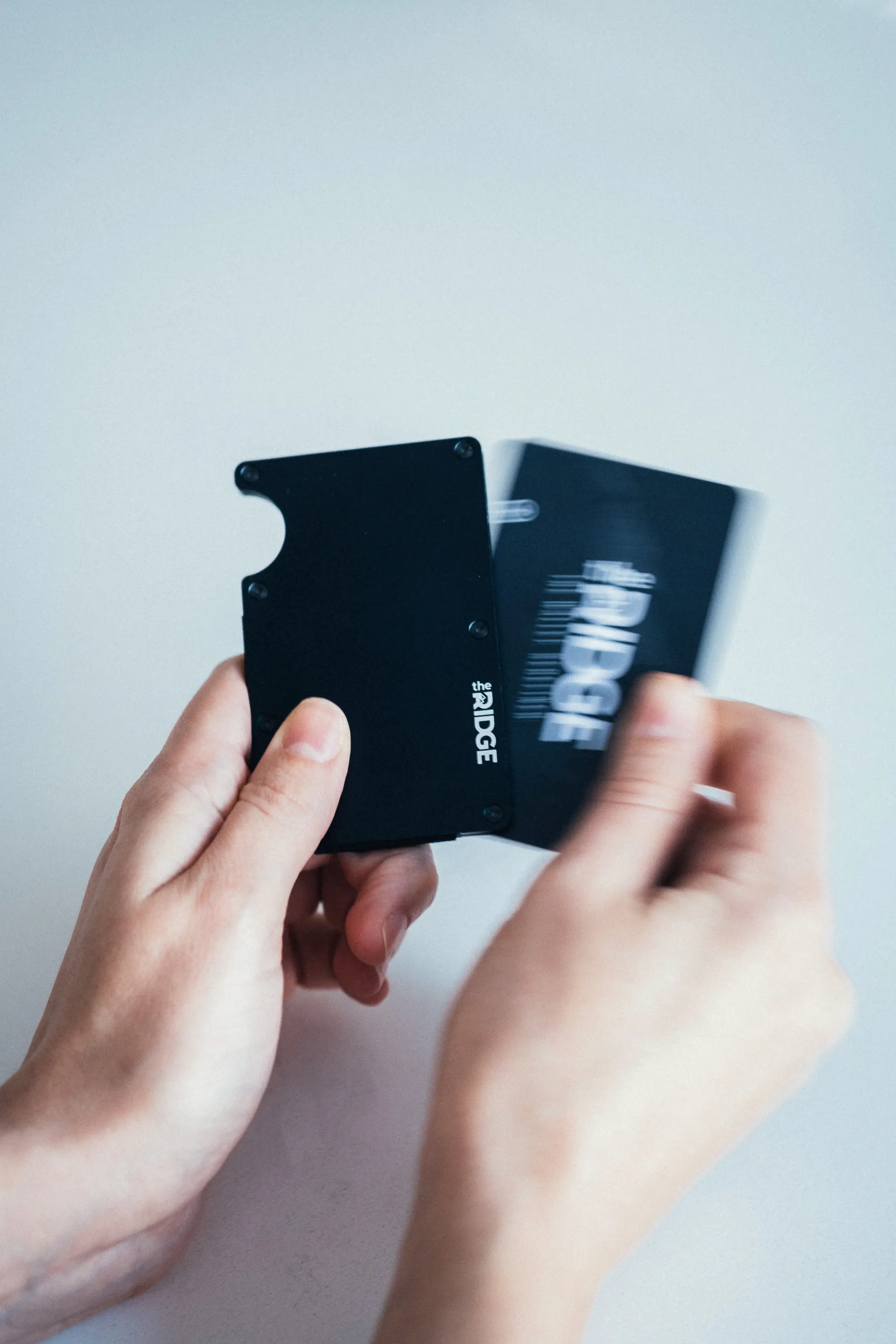 Woman pulling card out of ridge wallet