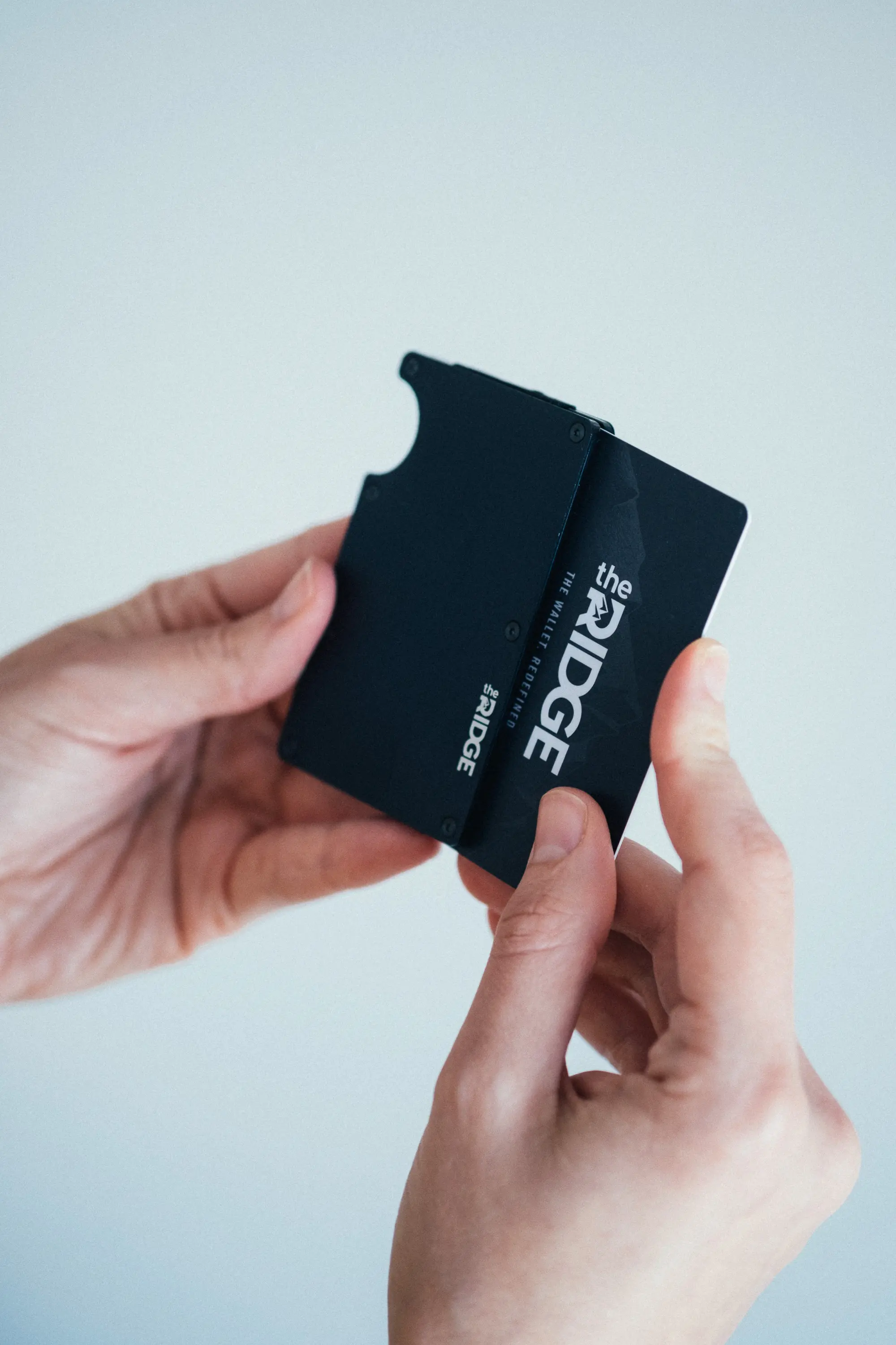 Woman pushing card into ridge wallet
