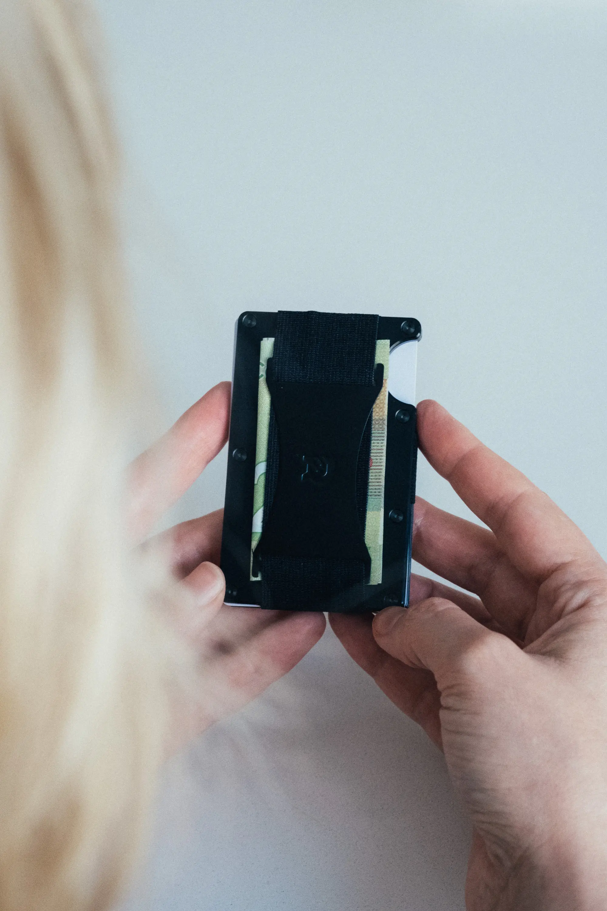 Woman holding up ridge wallet